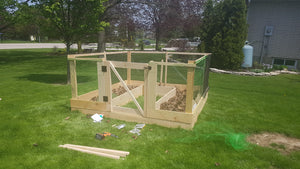 Raised walk in garden bed made with wood scraps